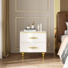 a white and gold nightstand in a bedroom