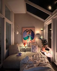 a living room with a couch, lamp and painting on the wall in it's corner