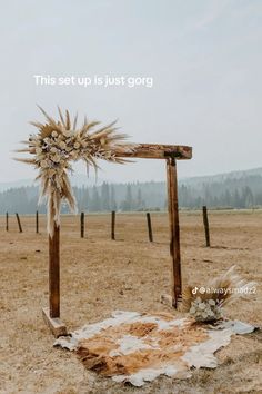 an old wooden structure in the middle of a field with flowers on it and a sign that says, this set up is just gore