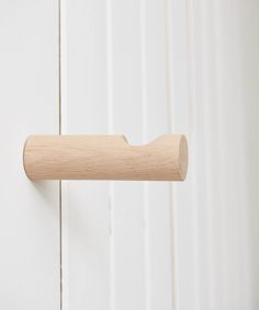 a close up of a wooden handle on a white door