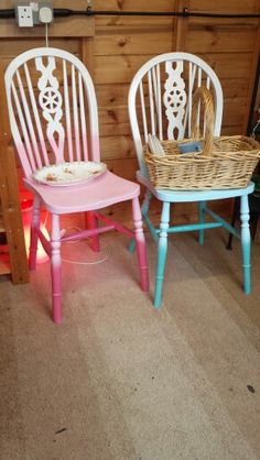 two wooden chairs painted pink and blue