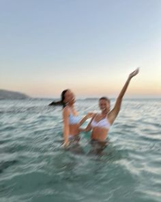 two women in the water playing with each other