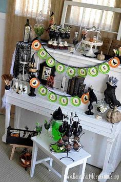 a white piano decorated for halloween with purple and green decorations