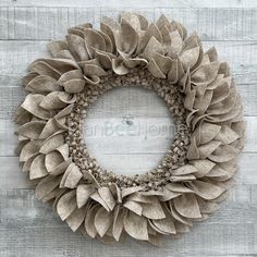 a wreath made out of fabric sitting on top of a wooden wall