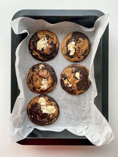 chocolate chip cookies with marshmallows are on a baking sheet, ready to be eaten