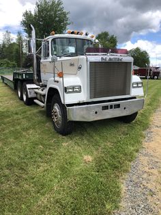 a large truck parked on top of a grass covered field