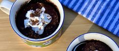 two mugs filled with chocolate pudding and whipped cream