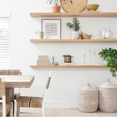 some shelves with plants and pictures on them