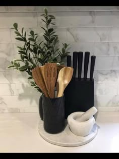 black and white kitchen utensils on marble counter top