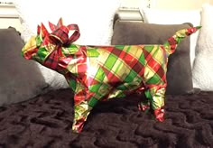 a dog made out of wrapping paper on a bed