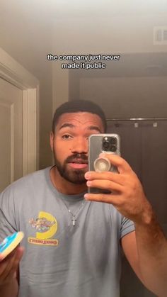 a man is taking a selfie in the mirror with his toothbrush and toothpaste