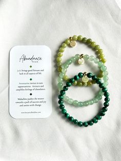 The abundance stack was created with the intention of attracting and inviting prosperity, wealth, and success into your life. Each of these gemstones carry a unique healing energy that assists with manifesting a dream life. These stones draw in opportunity, success, and abundance in regards to relationships, finances, career, and any other aspect of life. Whether you want to get rich with money or vibes, this is the stack for you. The energy exuding from these stones wants you to WIN.   Your purchase includes 3 bracelets, an information card highlighting some of the stones best qualities and healing abilities, and a satin pouch for storing. Bracelets include: - Jade Stacker - Aventurine Stacker -Malachite Stacker   Bracelets are composed of a sturdy, stretch elastic string, measuring appro Holistic Jade Jewelry For Meditation, Spiritual Green Malachite Beaded Bracelets, Green Malachite Spiritual Beaded Bracelets, Holistic Jade Beaded Bracelets As Gift, Green Gemstone Meditation Bracelets, Green Gemstone Bracelets For Meditation, Spiritual Jade Beaded Bracelets For Everyday, Green Agate Bracelets For Meditation, Everyday Spiritual Jade Beaded Bracelets