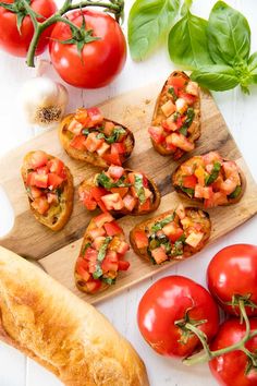 tomatoes, basil and bread on a cutting board