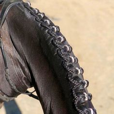 the back end of a horse's bridle with black paint on it