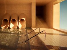 four urinals are in the middle of a swimming pool