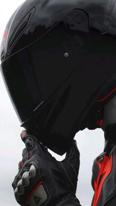 a person wearing a black and red motorcycle helmet