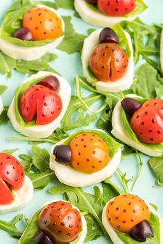 some little ladybugs are sitting on top of lettuce and tomato slices