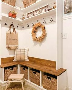 a bench with some baskets on it and a bag hanging from the wall next to it