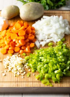 chopped carrots, onions and celery on a cutting board