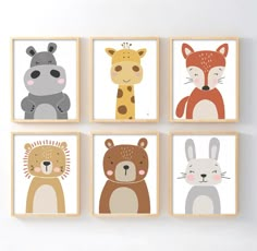 four framed pictures of animals are hanging on the wall in a child's room