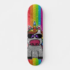 a skateboard with an image of a unicorn wearing sunglasses and a rainbow striped background