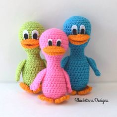 three crocheted stuffed animals sitting next to each other