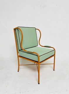 a green chair sitting on top of a white floor