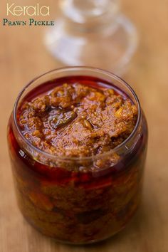 a jar filled with food sitting on top of a wooden table