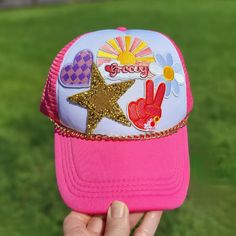 Check out this foam front hot pink patch hat that's perfect for anyone who loves to stand out in style! Featuring a "groovy" patch, a checkered heart, a glittery star, and more, this hat is pure personality. Whether you're dressing up your casual look or making a statement at your next event, this cap is all about bold, playful vibes with just the right touch of glam. Stay cool, stay trendy, and rock your one-of-a-kind style! Whether you're tailgating, cheering in the stands, or just showing your Tiger pride around town, this hat is your go-to for effortless, spirited style. Pink Patch, Patch Hat, Groovy Retro, Trucker Cap, Caps Hats, Casual Looks, Accessories Hats, Hot Pink, Dress Up