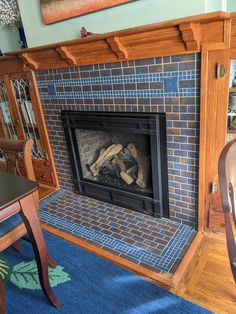 a fireplace in a living room with blue carpet