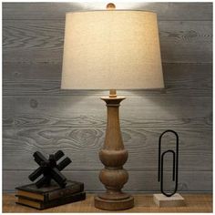 Base Dimensions: 5.25" W x 5.25" D Shade Dimensions: 10" H x 13.75" W x 13.75" D Full Height: 27.5" Cord Length: 60" Bulb Type: A 100W Power Source: Corded Electric Material: Resin, Fabric & Metal Color: Brown, Beige, Silver & White Quantity: 1 Round out your farmhouse room arrangement with this Wood Look Finial Table Lamp. The base features a tall finial shape with a rustic wood look and a large beige shade. Pair this with wood elements and faux greenery to tie the look together. Ranch Glam, Wood Base Lamp, Farmhouse Living Room Table, Farmhouse Table Lamp, Wood Lamp Base, Electric Material, Resin Fabric, Farmhouse Table Lamps, Rustic Decor Ideas