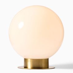 a white ball light sitting on top of a metal stand