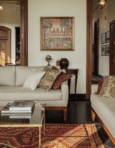 a living room filled with furniture and a painting on the wall