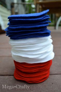 red, white and blue yarn is stacked on top of each other