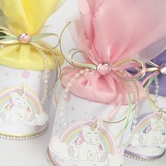 three unicorn themed candy boxes with ribbons tied around them