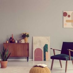 a living room filled with furniture and a book on top of a wooden table next to a potted plant