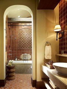 a bath room with a sink a tub and a mirror on the wall in it