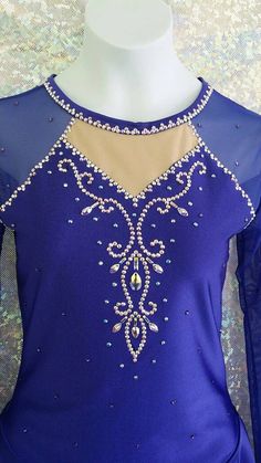 a woman's purple ballroom dress with beading and sequins on it