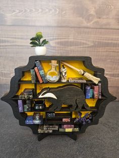 a wooden shelf with books and other items in it on top of a gray floor