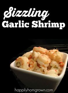 a white bowl filled with shrimp sitting on top of an open oven door next to a black background