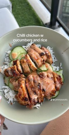 a plate with chicken, cucumber and rice on it that has the caption chilli chicken w / cucumbers and rice