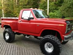 a red truck parked on top of a parking lot