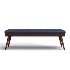 an upholstered bench with wooden legs and a blue cushion on the top, against a white background