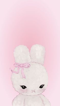 a white stuffed animal with a pink bow on its head and eyes, sitting in front of a pink background