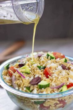 a bowl filled with rice and vegetables being poured into it