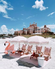 beach chairs and umbrellas are set up on the sand near an ocean front hotel