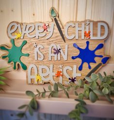 a wooden sign that says every child is an artist