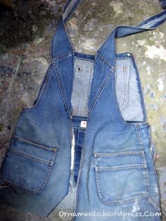 an old pair of jean overalls is laying on the ground