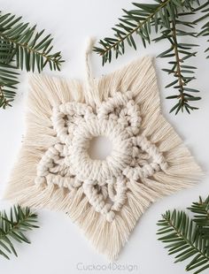 a white ornament hanging from a christmas tree