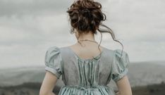 a woman standing on top of a lush green field